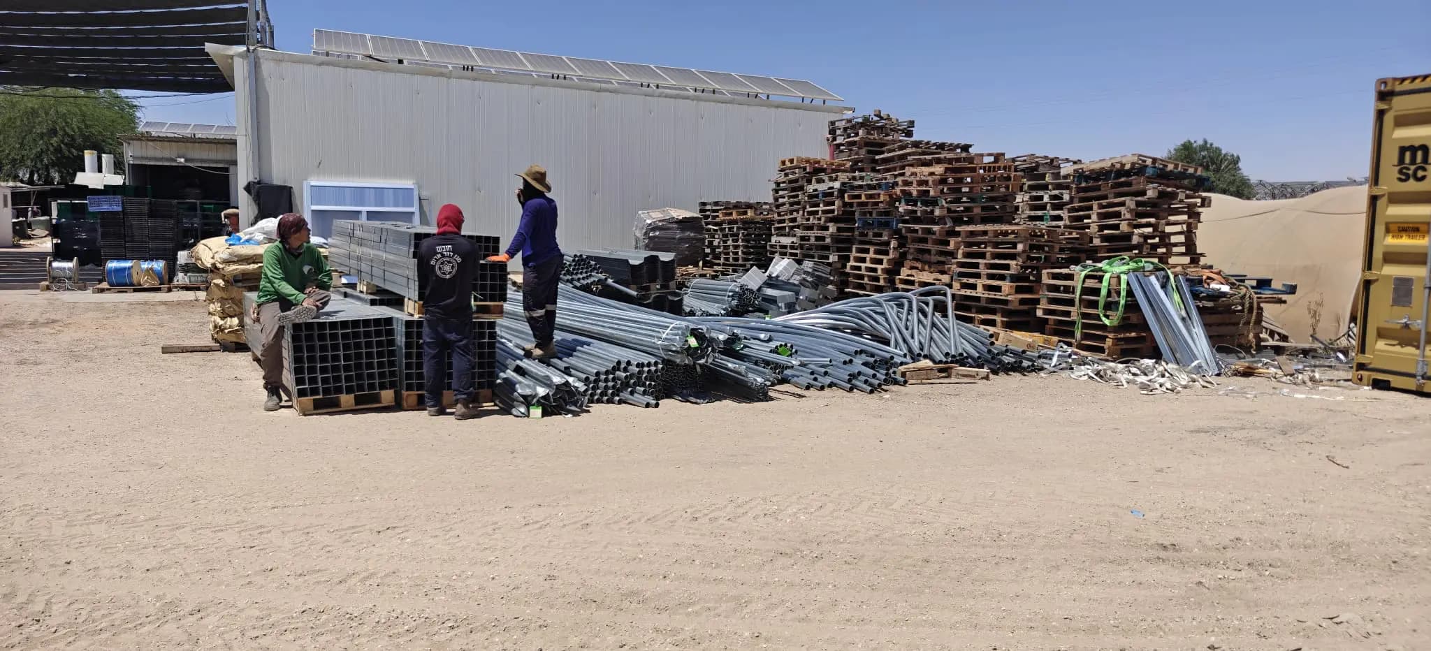 Technical team preparing greenhouse framing on site