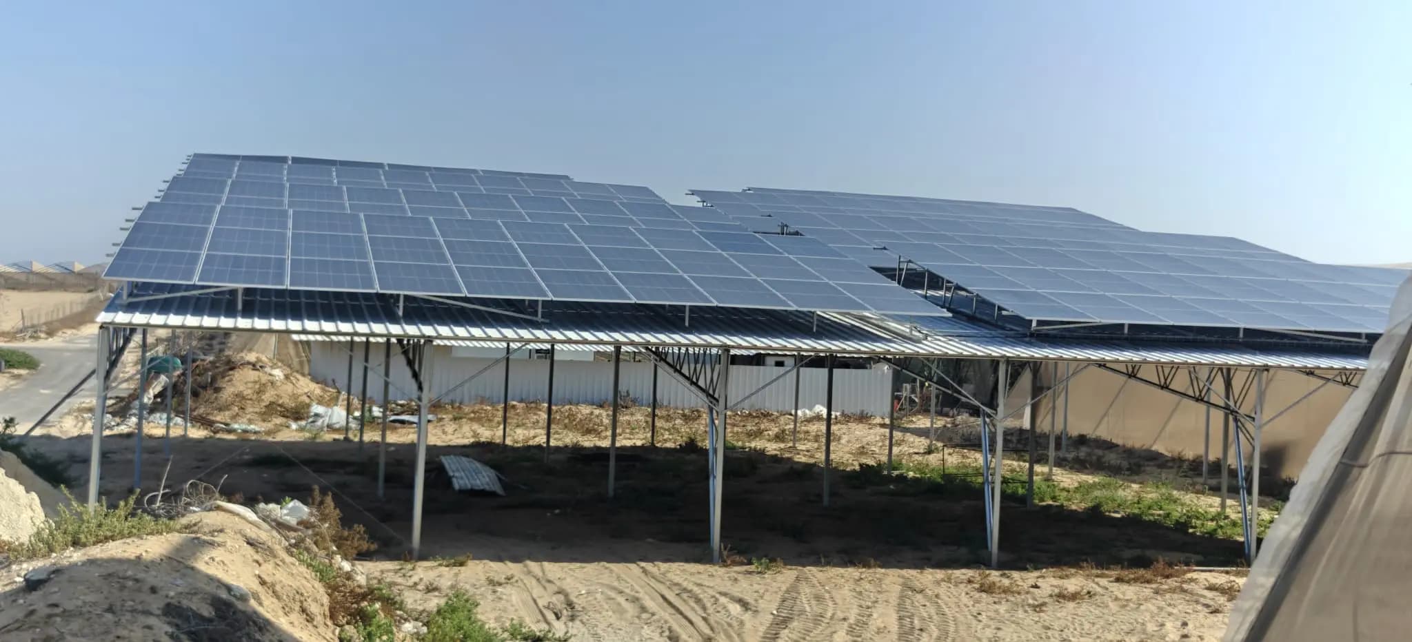 Solar array structures over farm infrastructure
